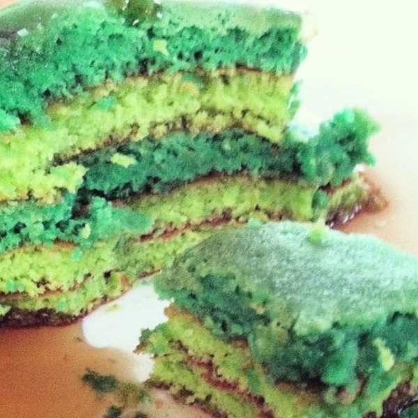 Green pancakes on a plate sliced down the middle