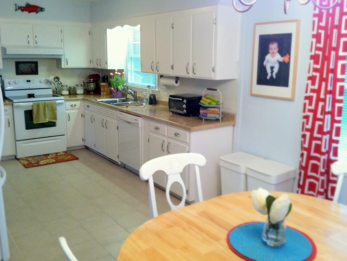 a clean kitchen with white cabinets