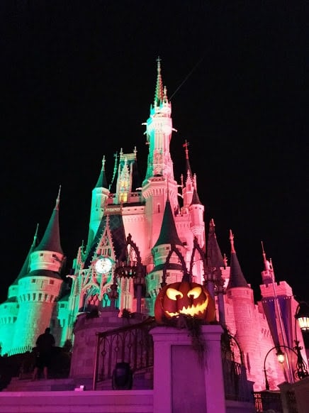 Disney Halloween Pumpkin in front of Halloween Cinderella Castle in Magic Kingdom.