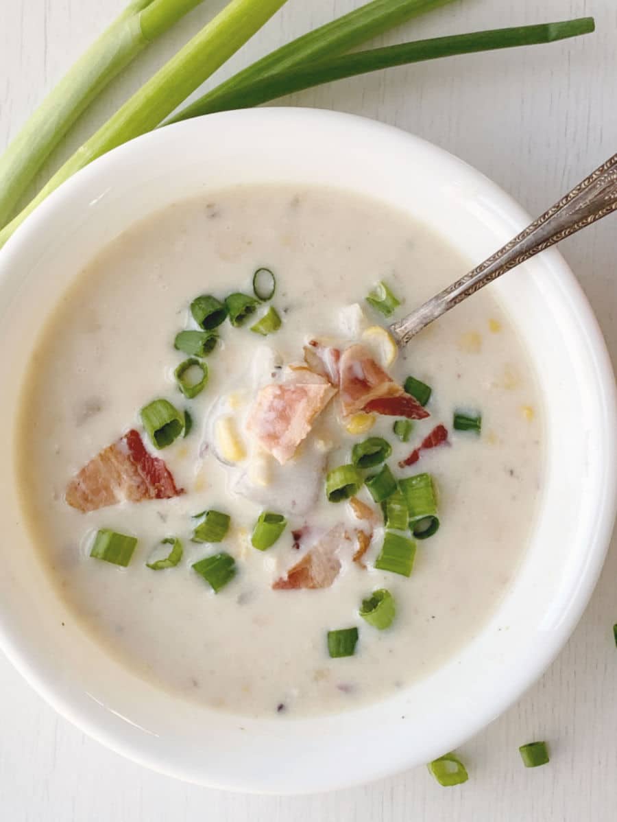 Corn Chowder in bowl with bacon and green onions