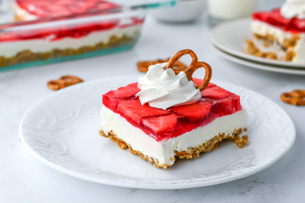 Strawberry cheesecake with pretzels on a plate is a delicious dessert combining the flavors of strawberries and pretzels.