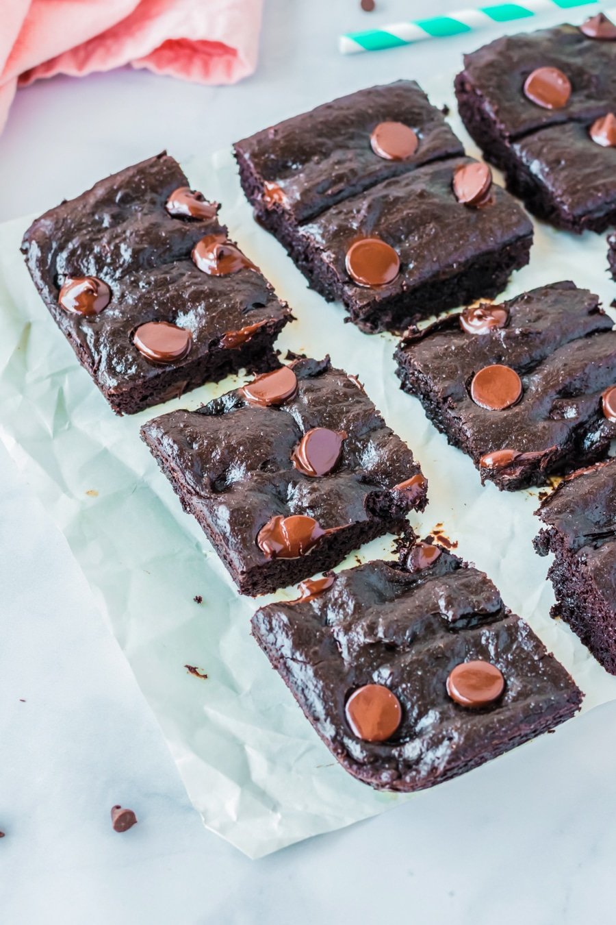 cooked avocado brownies cut into squares on parchment paper