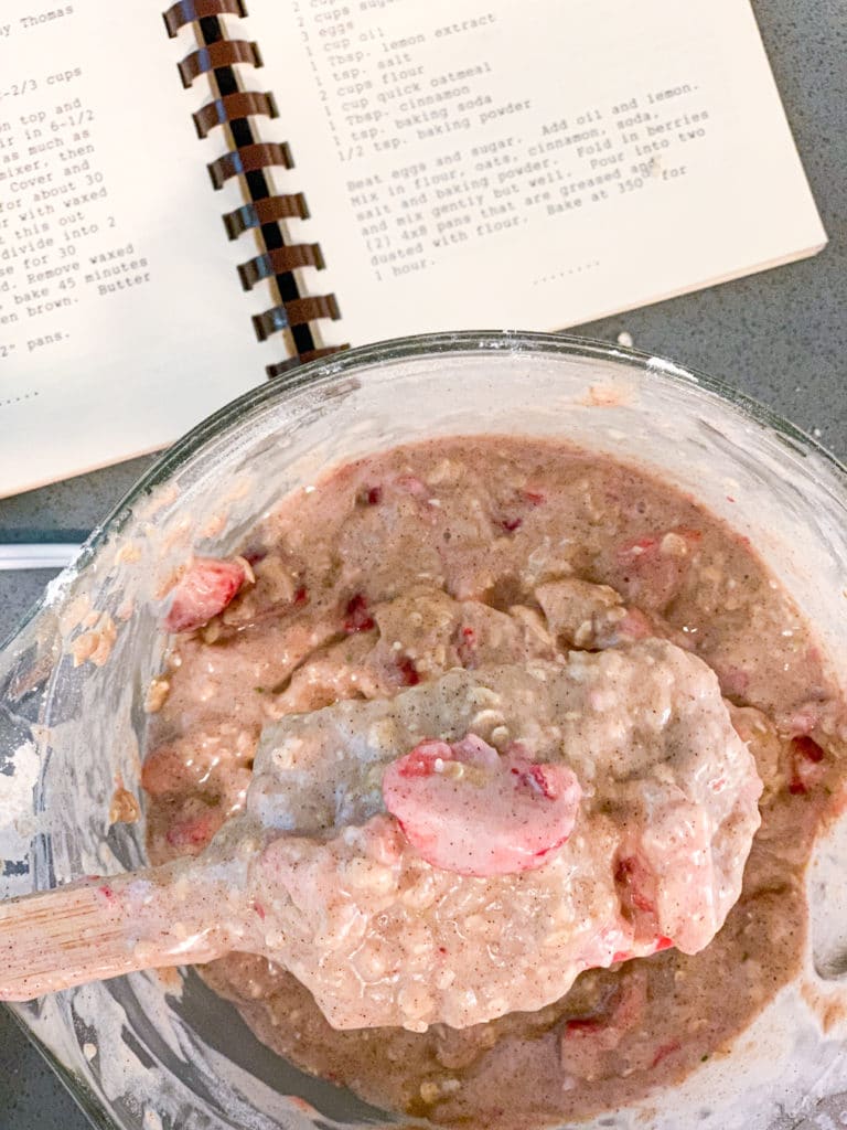 strawberry bread batter with cookbook in the background