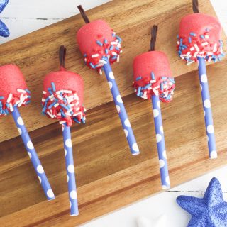fire cracker marshmallow pops laying on a cutting board