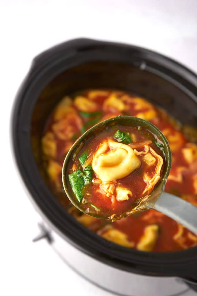 slow cooker tortellini soup in ladle
