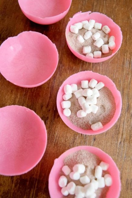 candy half-spheres filled with dry hot cocoa and marshmallows