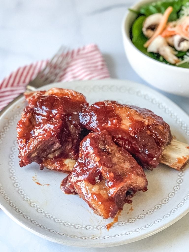 broiled ribs on a plate with salad