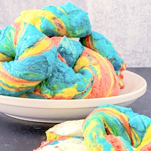 rainbow bagels on a plate sliced