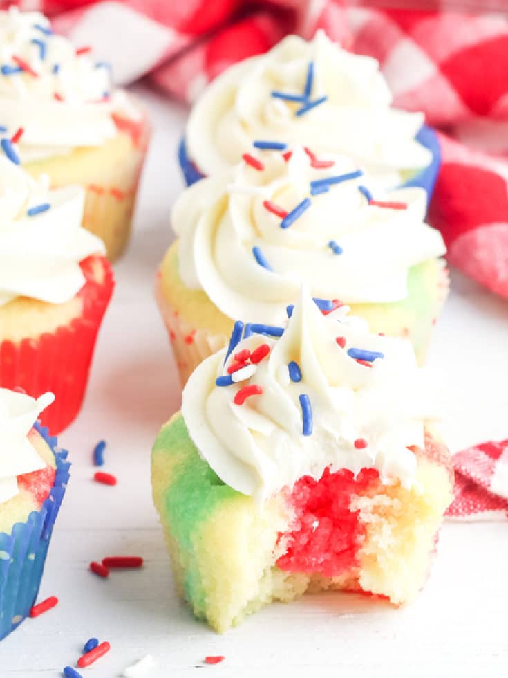 red white and blue cupcakes one with a bite out of it