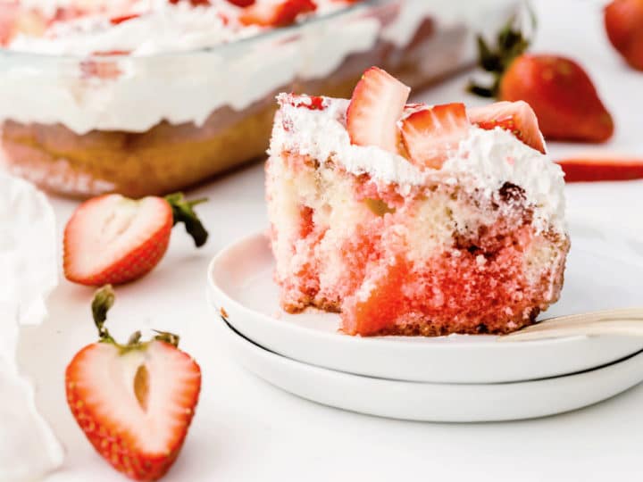 Strawberry poke cake slice with bite