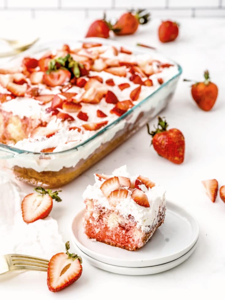 Strawberry poke cake with slice on plate
