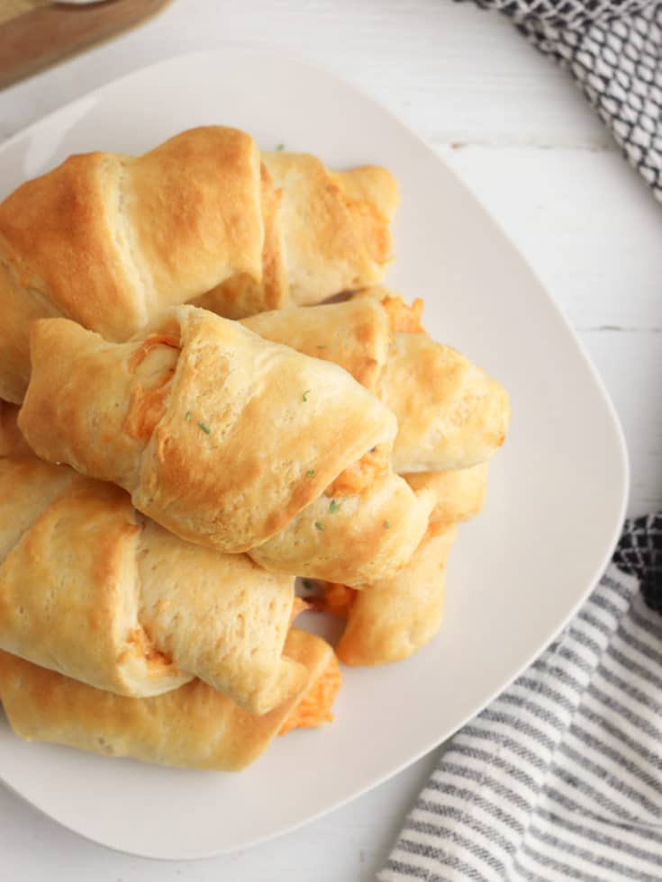 chicken crescents piled on a white plate