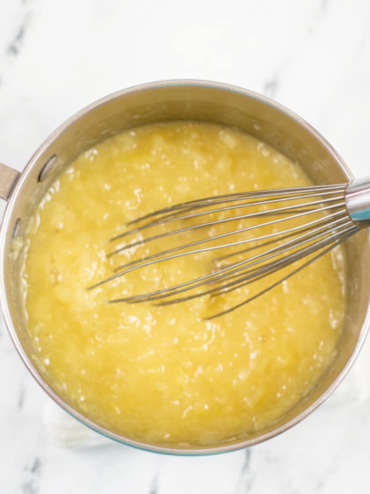 add crushed pineapples to saucepan and whisk together