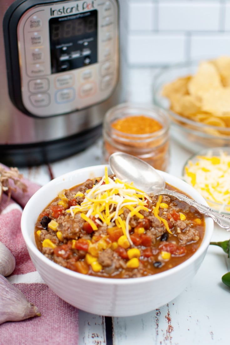 instant pot taco soup with shredded cheese in bowl