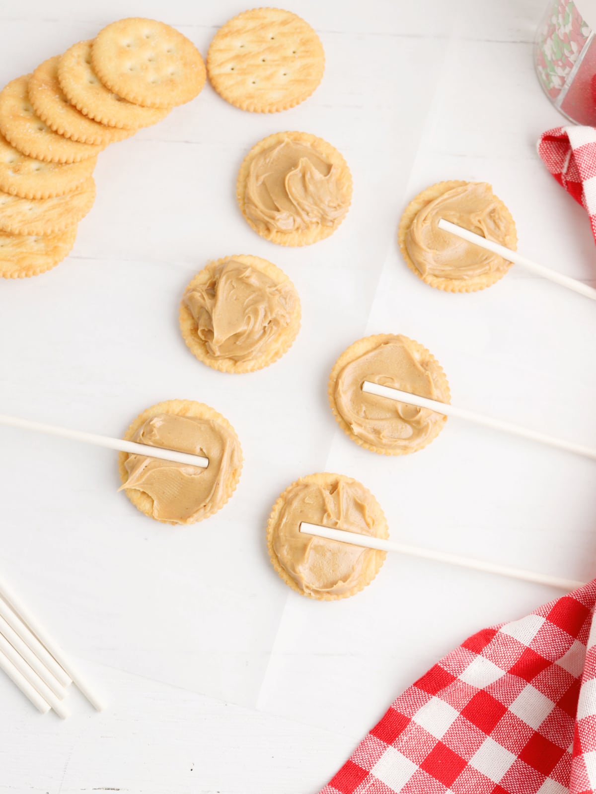 peanut butter on crackers with lollipop stick