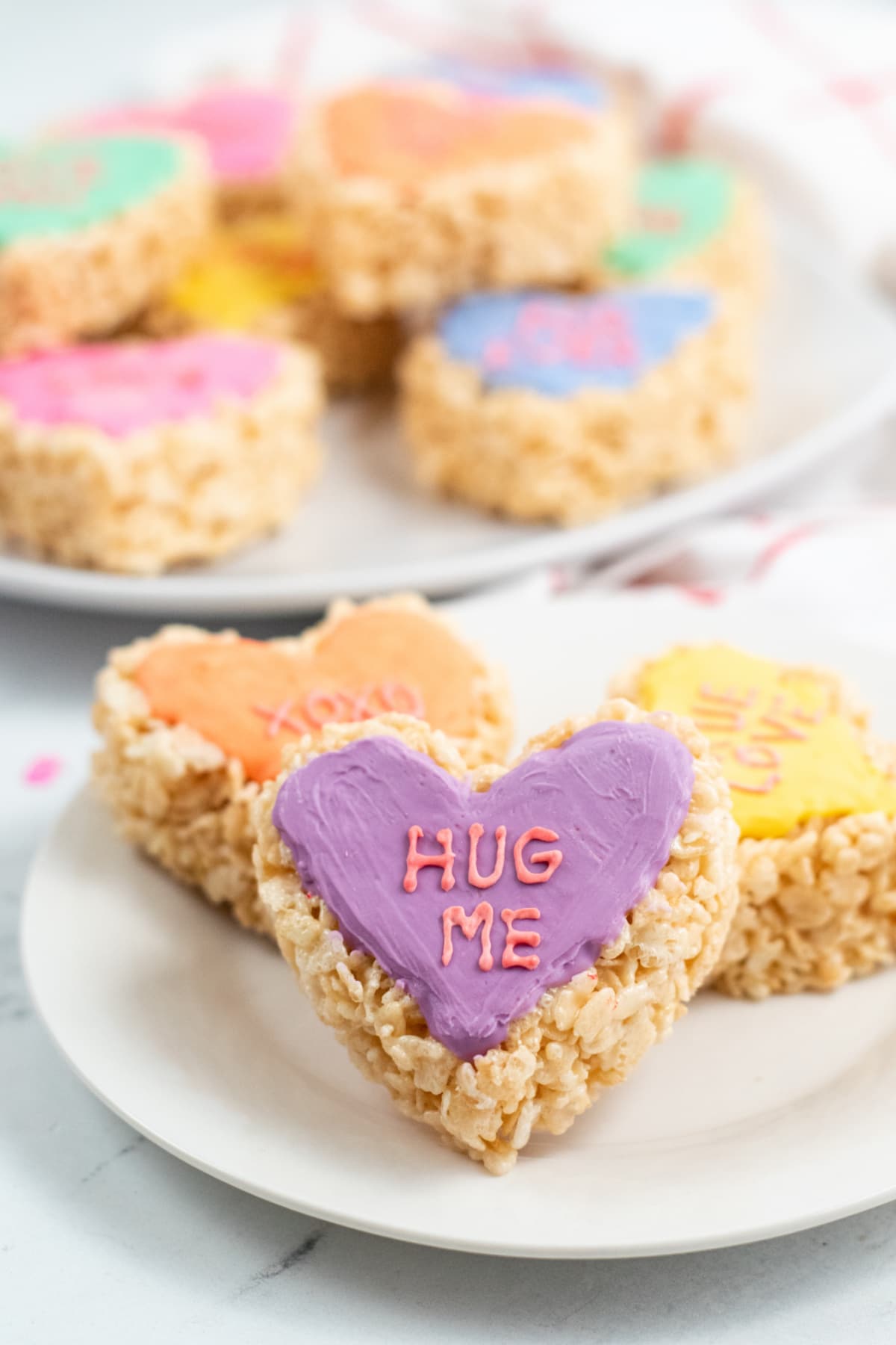Colorful Rice Krispie Treat Conversation Hearts on a plate