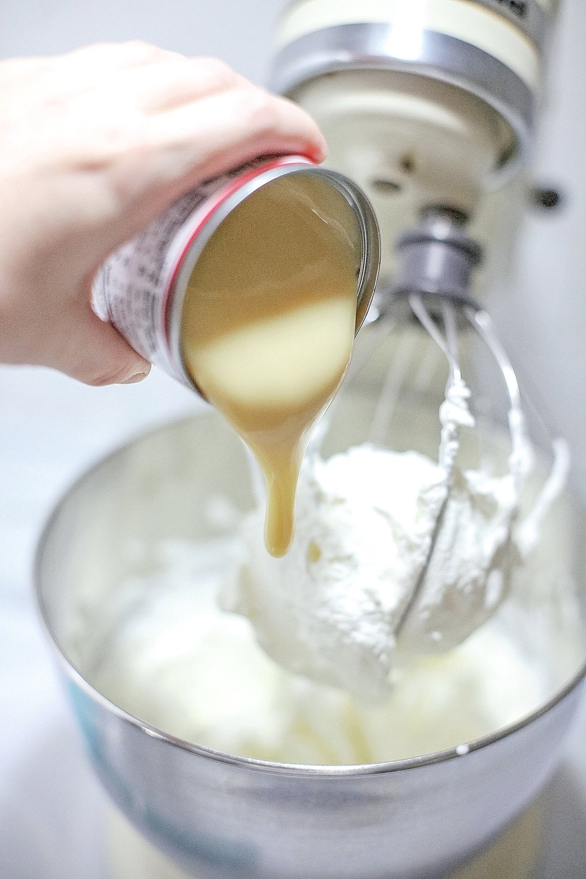 Add condensed milk to whipped cream