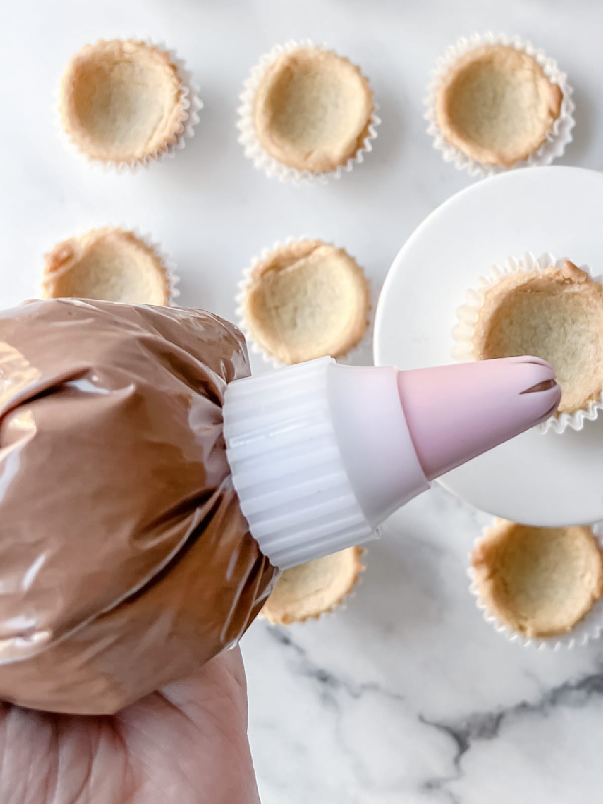 chocolate frosting in piping bag
