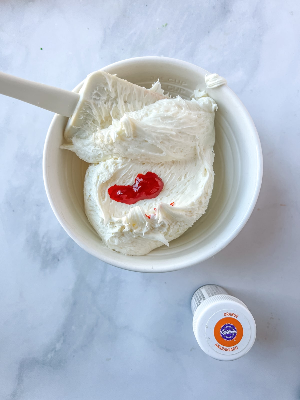 vanilla frosting with orange gel food coloring