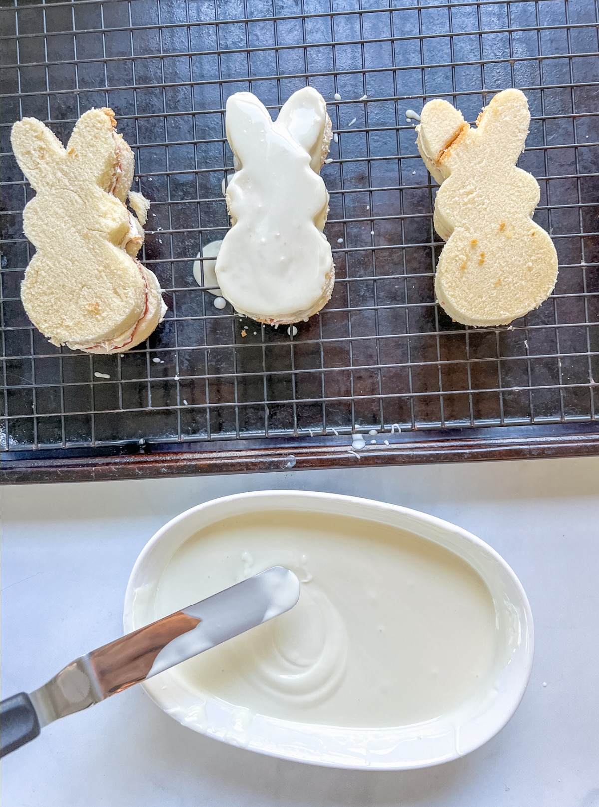 Dip bunny cakes in white melting chocolate