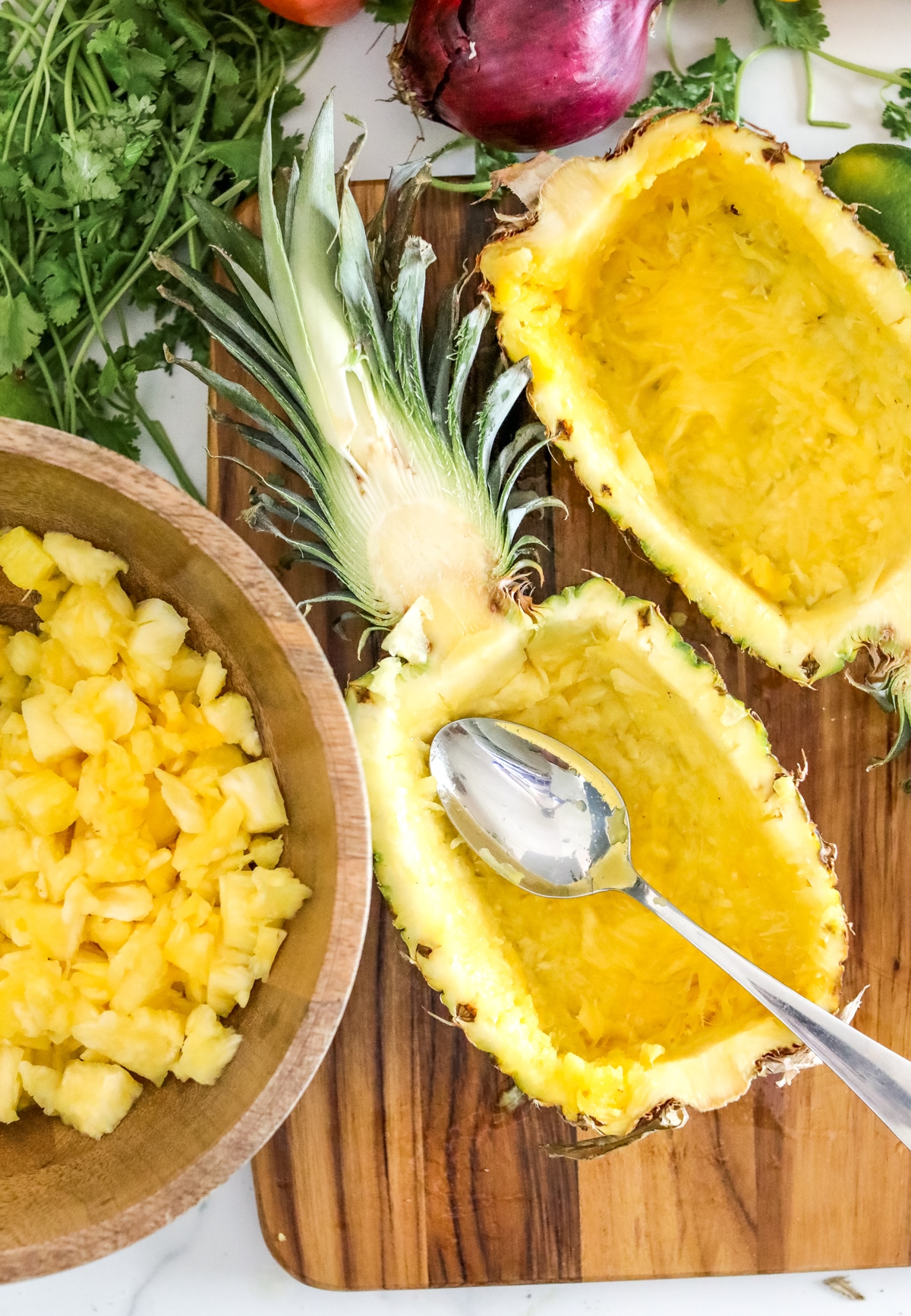 Evenly scoop out pineapple bowls