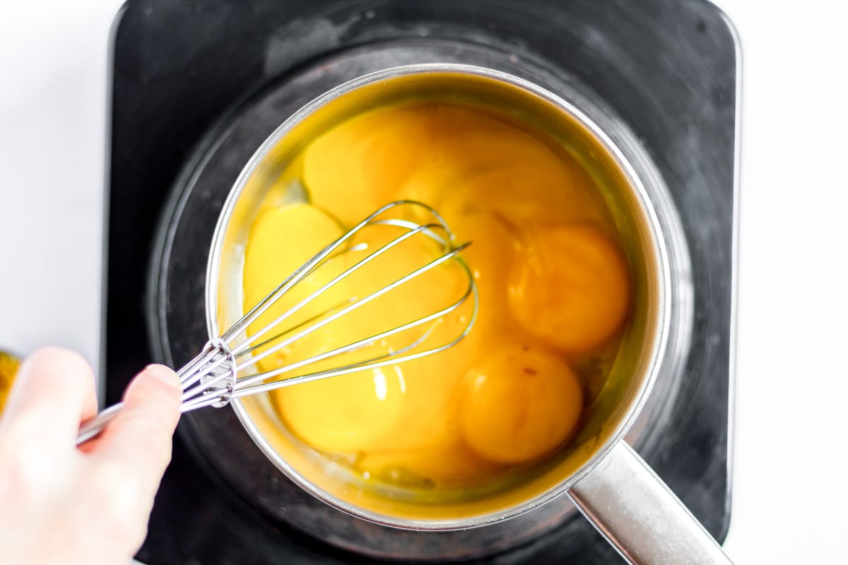 beat eggs with a whisk over heat