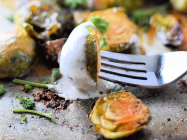 Buffalo Ranch Brussel Sprouts Bite on Fork with ranch dressing