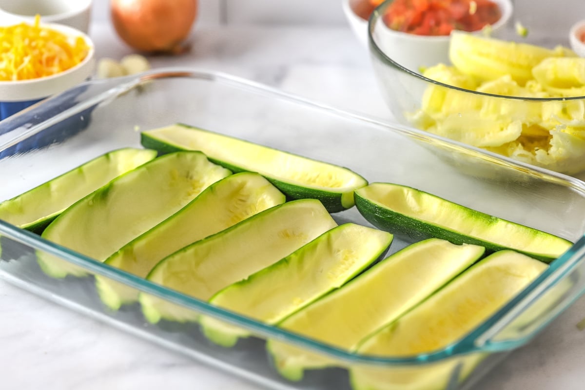 Place scooped out zucchini in a baking dish