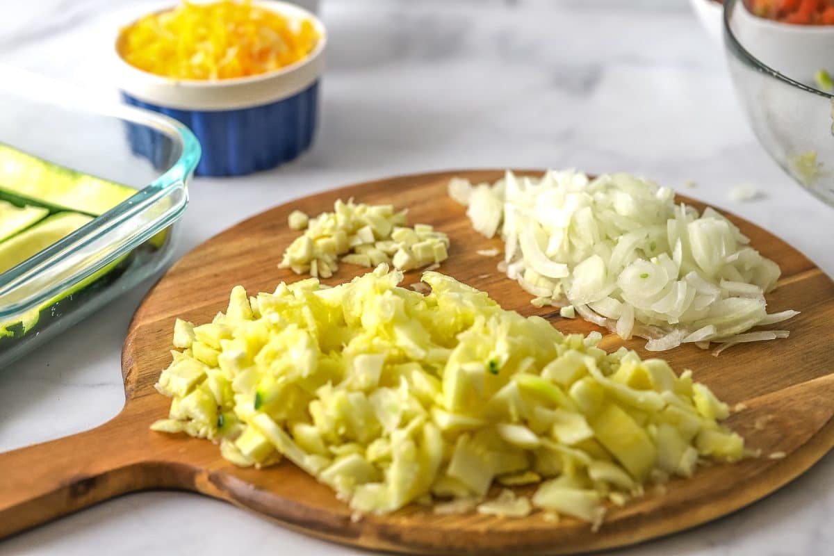 Scoop out zucchini and dice with onion