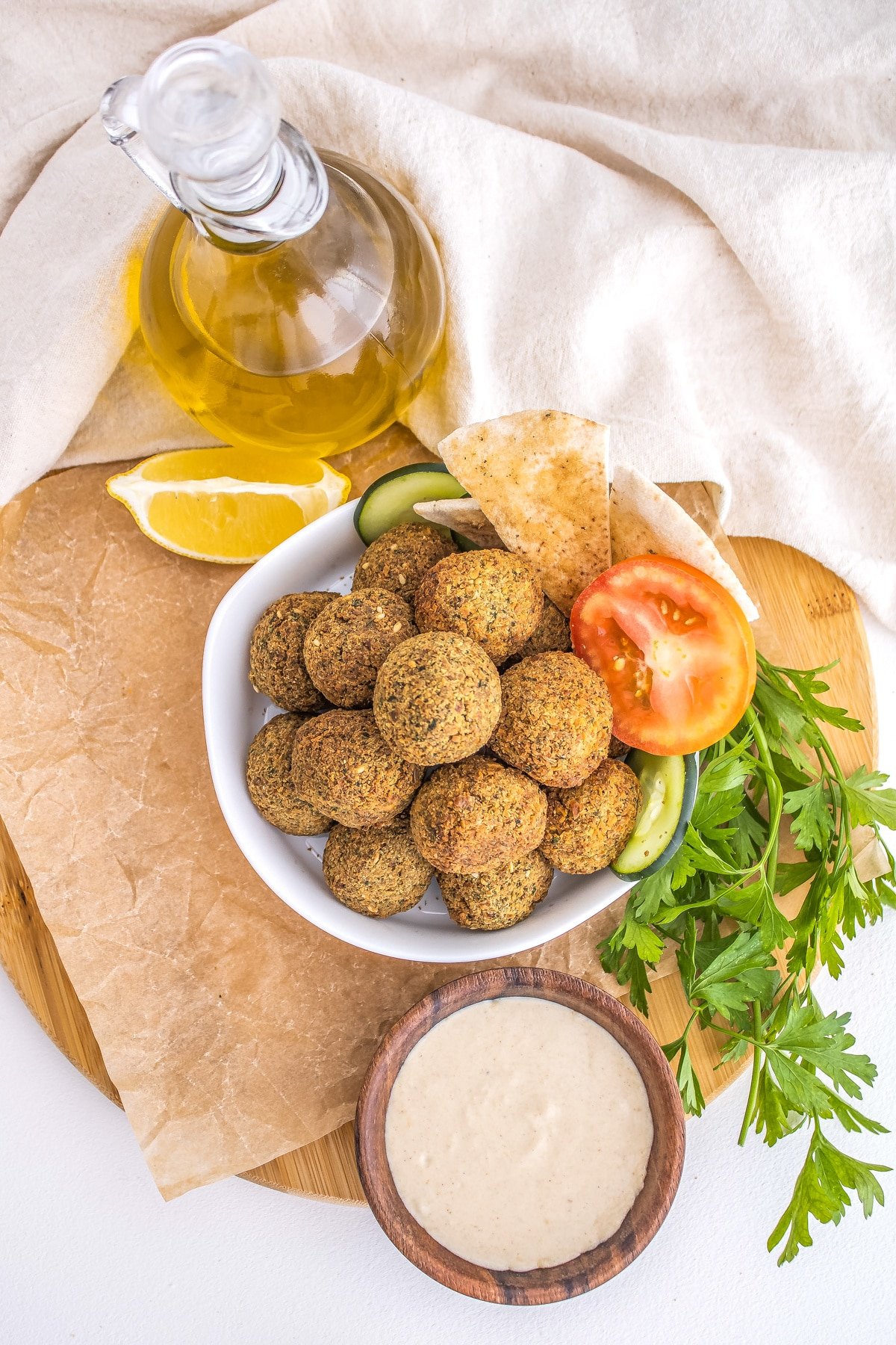 Air Fryer Falafel overhead with hummus in a bowl and olive oil in a pitcher