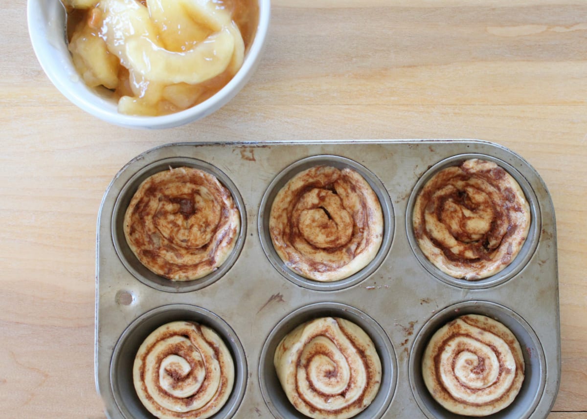 press cinnamon rolls into muffin tin