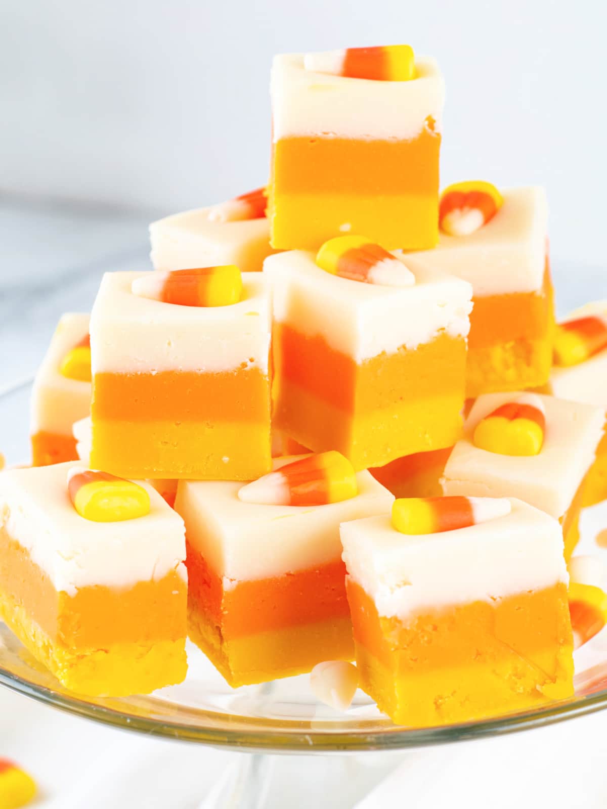 Candy Corn Fudge squares stacked on serving platter