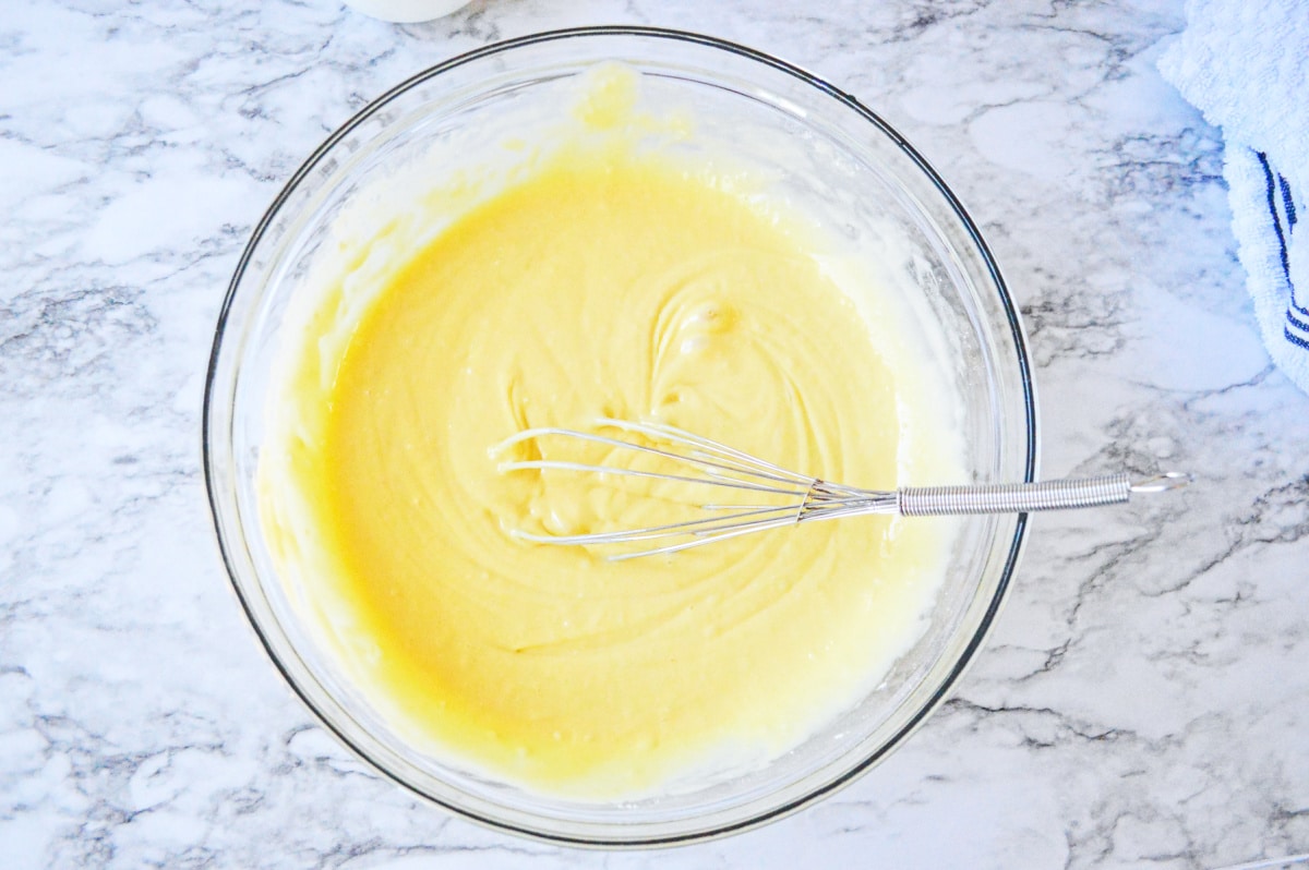 cake batter in a glass bowl with whisk