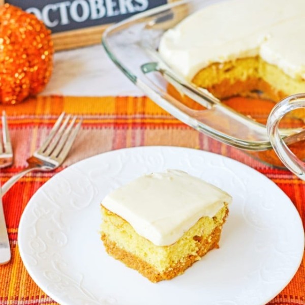 slice of pumpkin cake on a white plate with the pan in the background