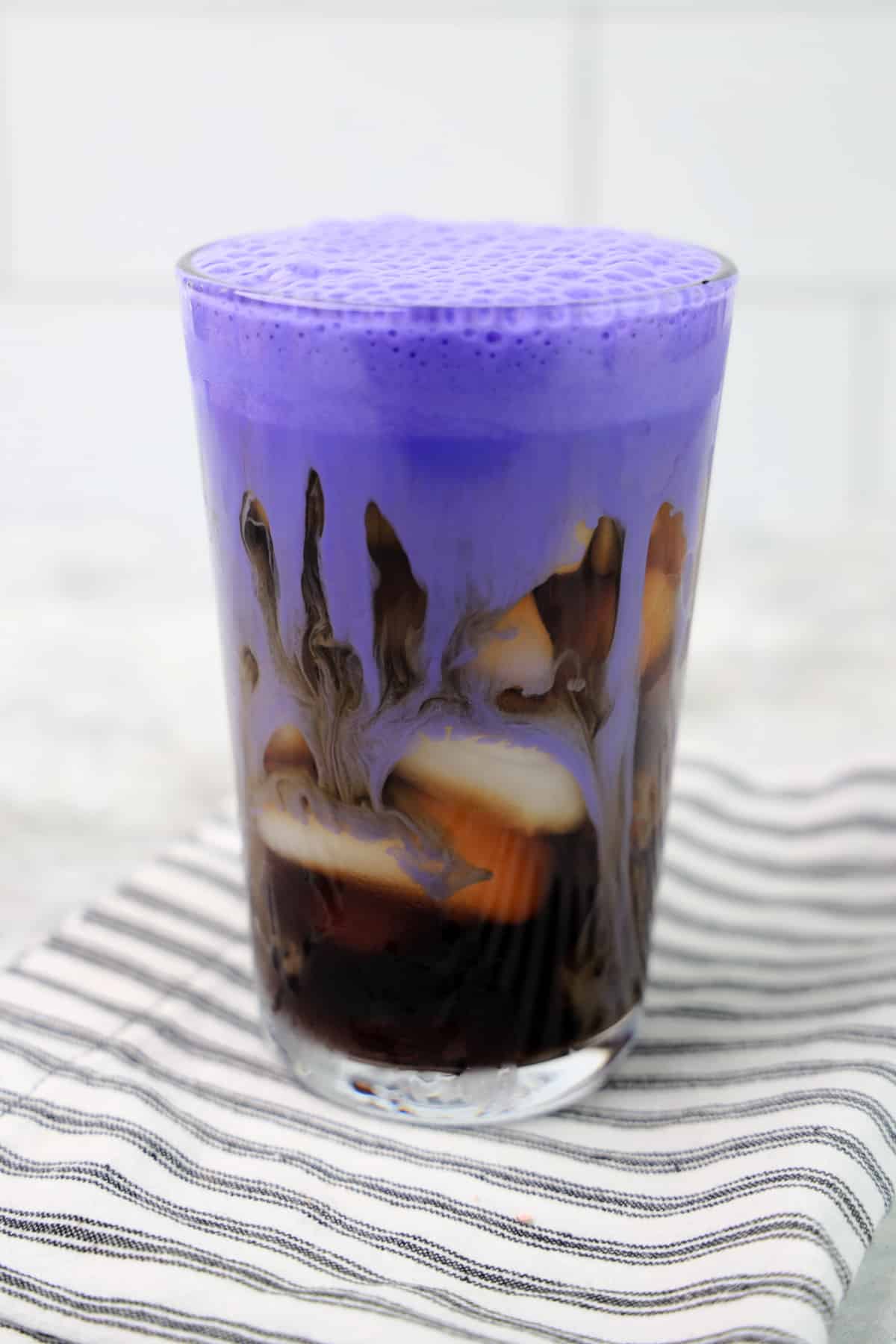Pour purple cream over coffee