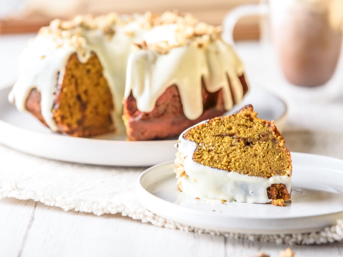 slice of iced pumpkin cake on a plate