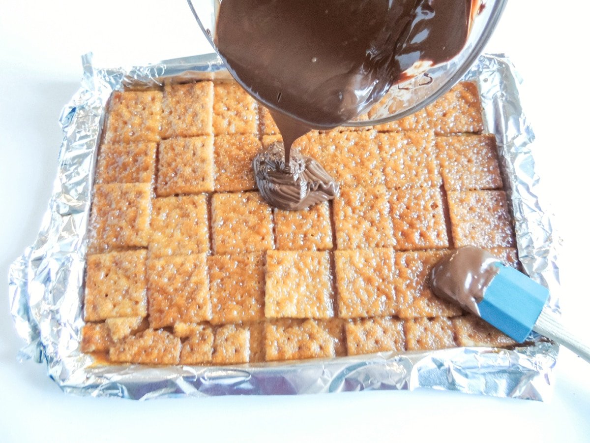 pour chocolate over baked crackers