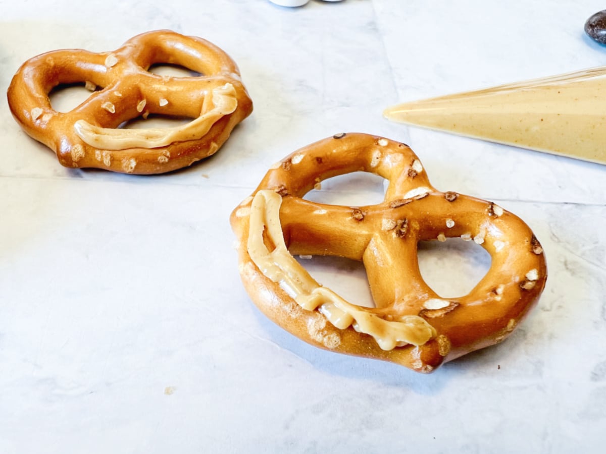 add frosting to pretzels