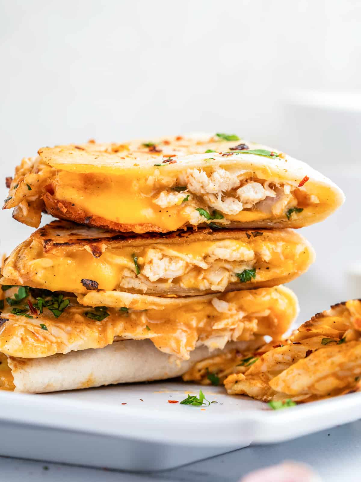 warm buffalo chicken quesadillas stacked on a plate