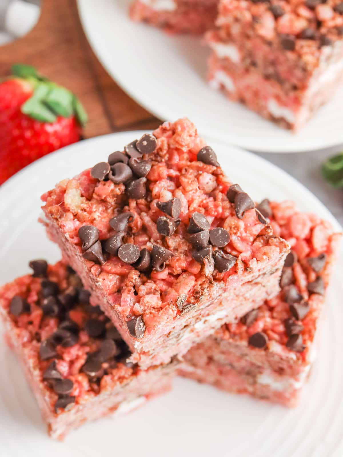 Strawberry Rice Krispie Treats with Chocolate Chips on white plates