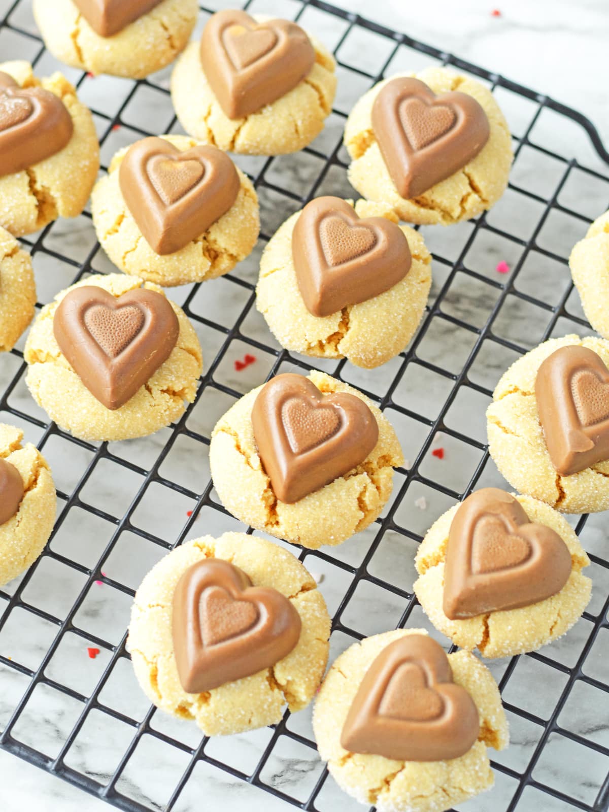 press chocolate peanut butter hearts into warm cookies