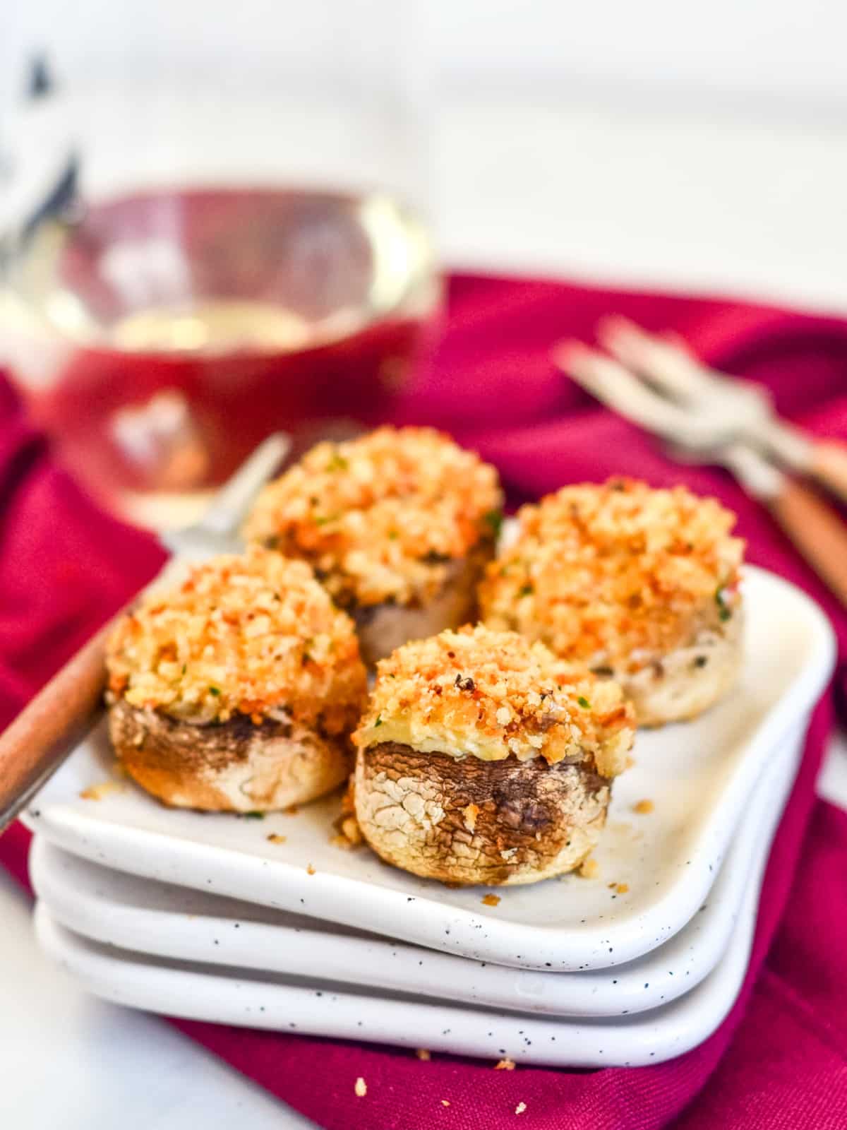 stuffed mushrooms on appetizer plate with white wine