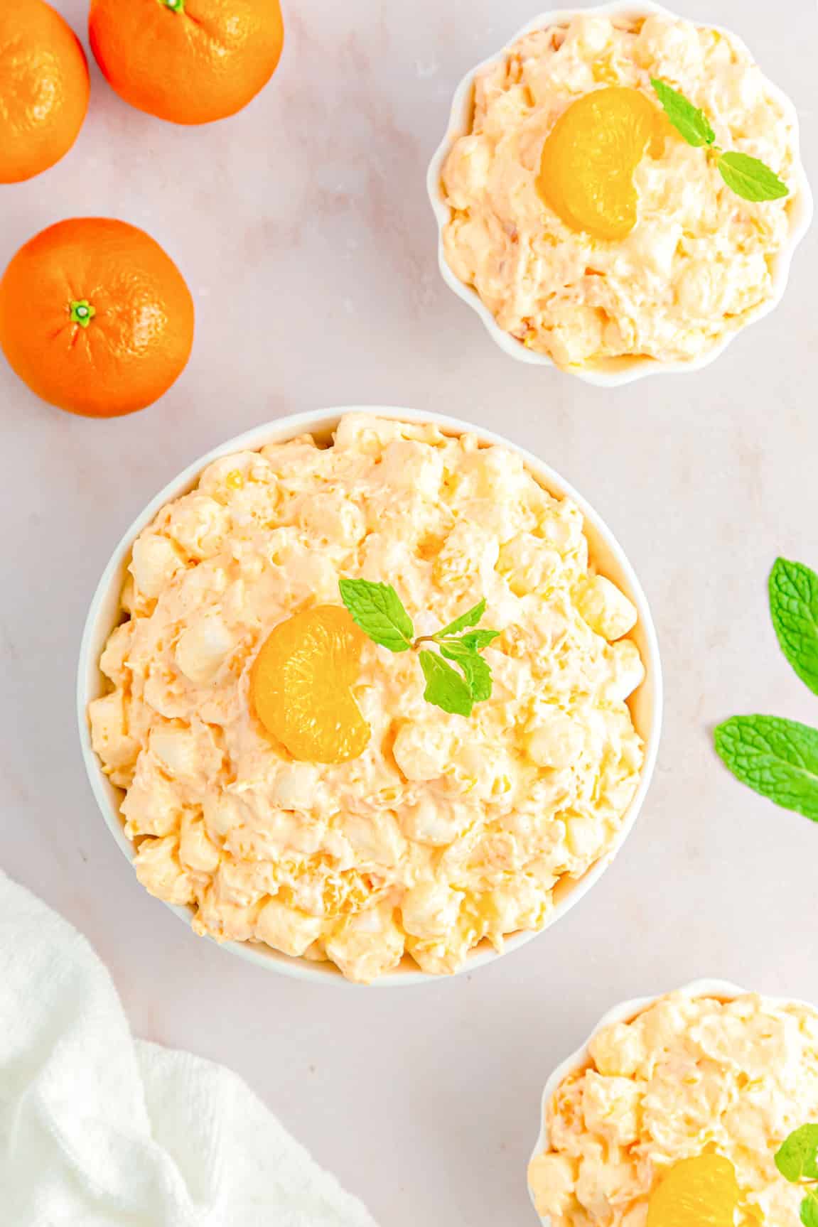 Orange Fluff with mandarin oranges on top in serving bowls