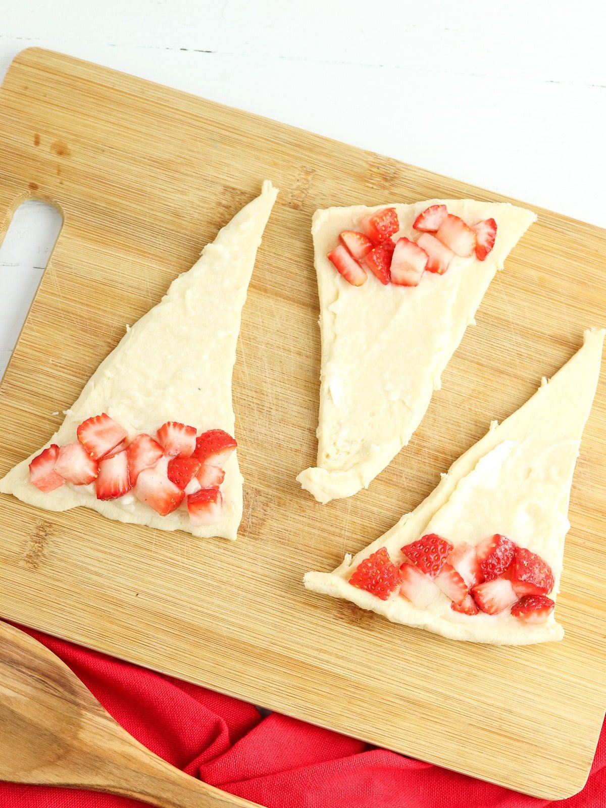 add cream cheese and strawberries to crescent dough