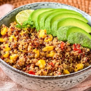 Spicy Quinoa Mexican style in a bowl with avocado and lime