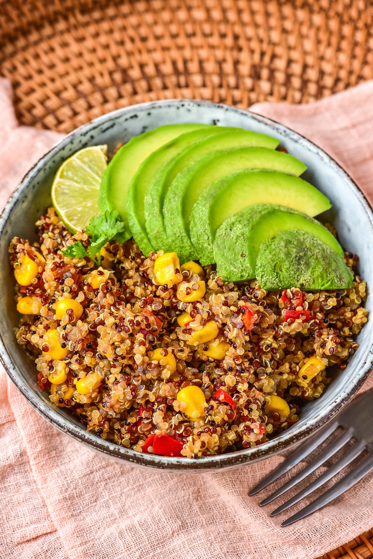 Spicy Quinoa in bowl with sliced avocado