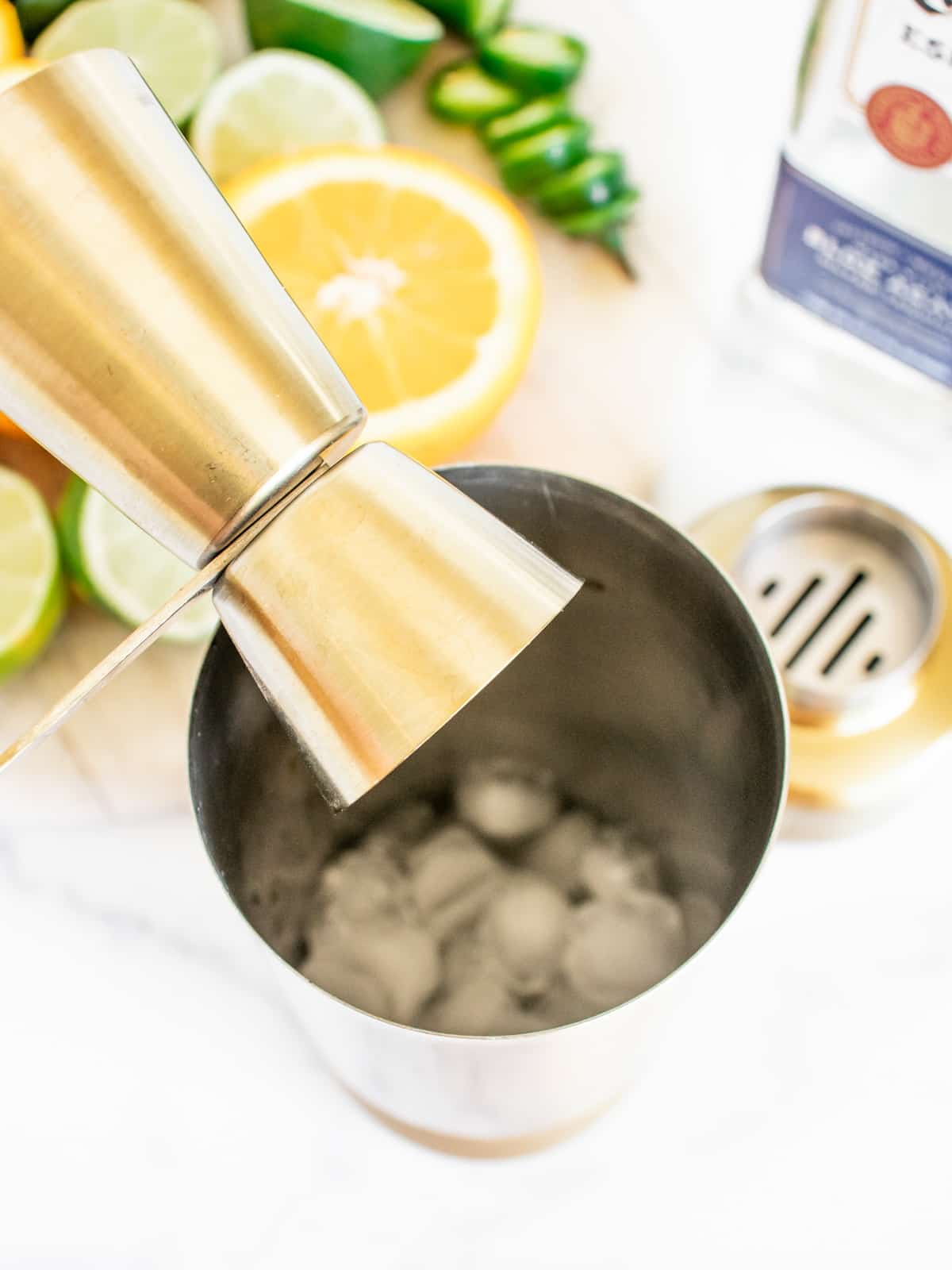 add tequila to ice and juice in shaker