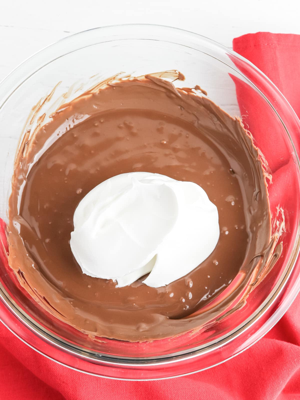 cool whip with melted chocolate in glass bowl