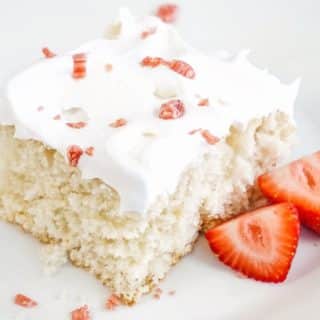 cream soda cake slice on a plate with strawberries