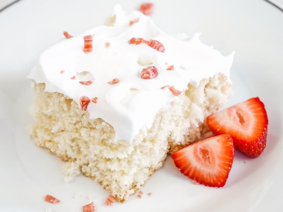 cream soda cake slice on a plate with strawberries